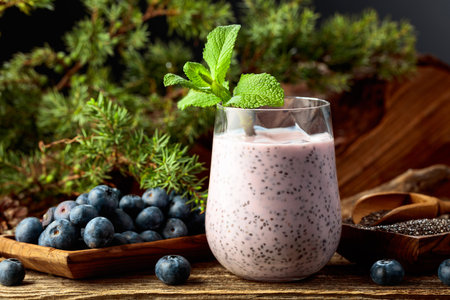 Blueberry smoothie with chia seeds and fresh berries on a pine stump. Healthy eco food from the heart of the forest. Concept of eco food.の写真素材