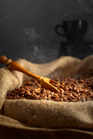 Fresh roasted coffee beans and wooden scoop in burlap bag. Copy space.の写真素材