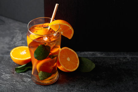 Iced tea or a summer refreshing drink with ice, mint, and orange. Copy space.の写真素材