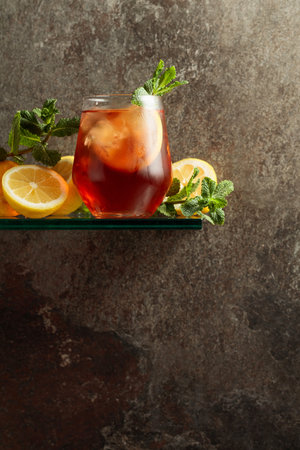Iced tea in a frozen glass. A refreshing drink with ice, lemon, and mint. Copy space.の写真素材