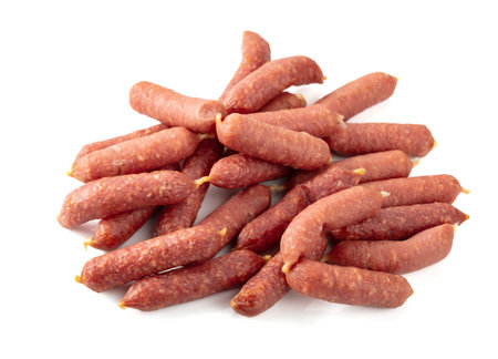 Small dry-cured sausages isolated on a white background.の写真素材