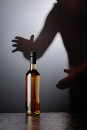 Bottle of white wine on a black table. Copy space.の写真素材