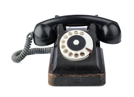 Vintage black phone with rotary dial isolated on a white background.の写真素材