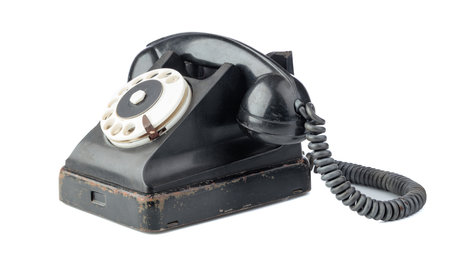 Vintage black phone with rotary dial isolated on a white background.の写真素材