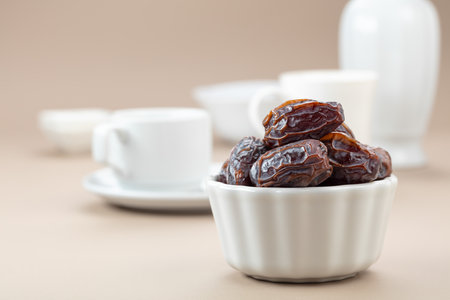 Dried medjool dates in white dish on a beige background.の写真素材