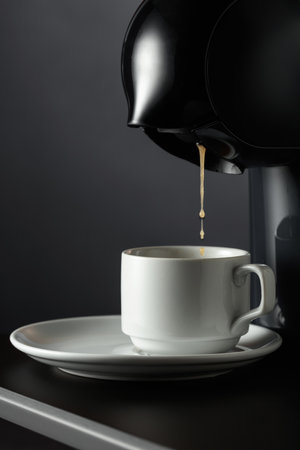 Espresso machine making fresh coffee. Black background with copy space.の写真素材