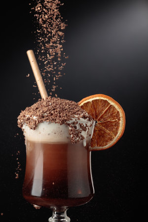 Chocolate cocktail with whipped cream sprinkled with chocolate chips and garnished with a dried...
