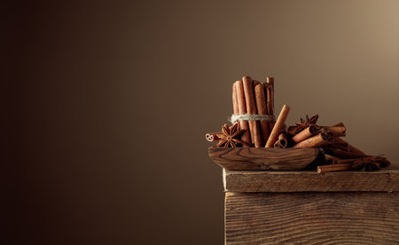 Cinnamon sticks and anise on an old wooden table. Copy space.の写真素材