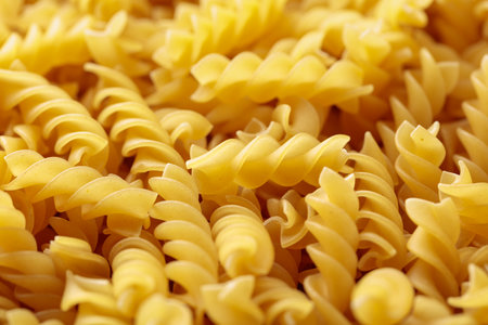 Fusilli doppia rigatura pasta background. Selective focus.の写真素材