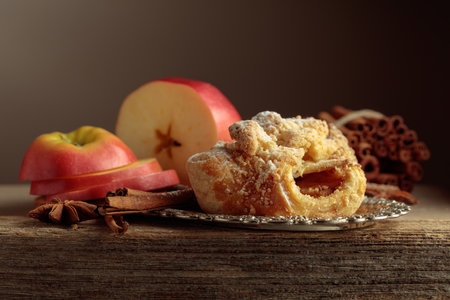 Viennese strudel with apple, cinnamon, and anise on old wooden table. Copy space.の写真素材