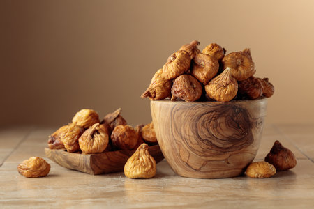 Organic dried figs on a ceramic table. Beige background with copy space.
