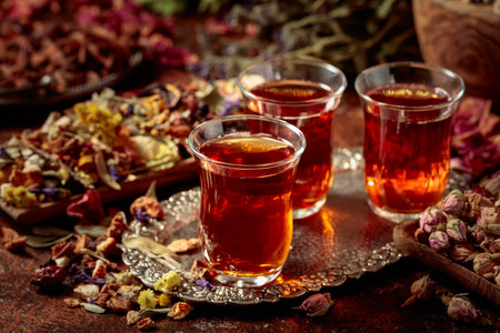 Herbal tea and various dried medicinal plants and herbs on a brown vintage background.