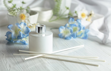 Luxury aromatic scent of reed diffuser white glass bottle is used as room freshener on the white...