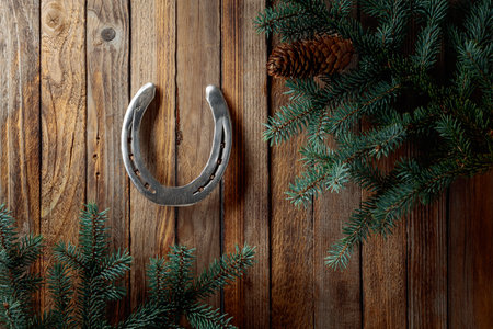 Horseshoe and spruce branches. Old wooden background. Copy space.の写真素材