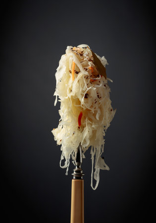 Traditional German sauerkraut with spices on a fork.の写真素材