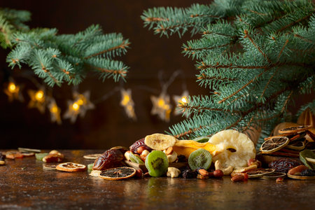 Dried tropical fruits with various nuts and raisins on an old brown table. Sweet tropical fruits on a kitchen table.の写真素材