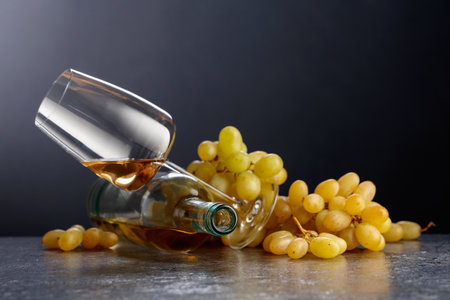 Grapes and white wine on a black background. Copy space.の写真素材