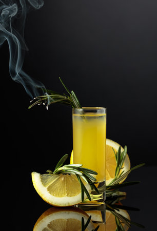 Italian liqueur limoncello with lemon slices and rosemary branch.の写真素材