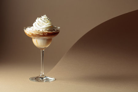 Cream and coffee cocktail on beige background. Copy space.