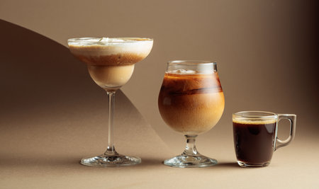 Black coffee and iced coffee cocktails on a beige background. Copy space.