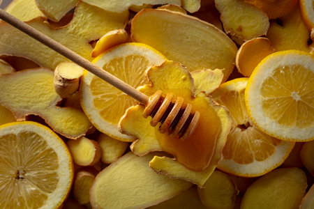 Honey with fresh ginger and lemon slices. Ingredients for winter healthy drink. Top view.