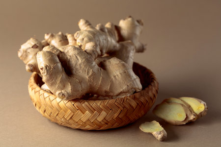 Fresh ginger root on a beige background.の写真素材