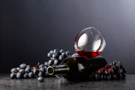 Grapes and red wine on a black background. Copy space.の写真素材