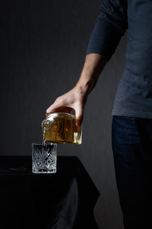 Man pouring strong alcoholic drink in glass. Copy space.の写真素材