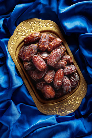 Dates on a golden platter are a symbol of generosity and ancient traditions in the Arab world. These...