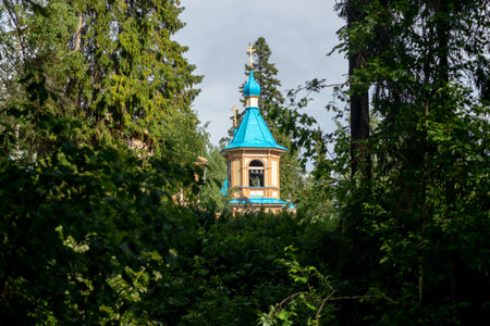 The Bell Tower of the Church of the Assumption of the Blessed Virgin of Valaam among the treesの写真素材