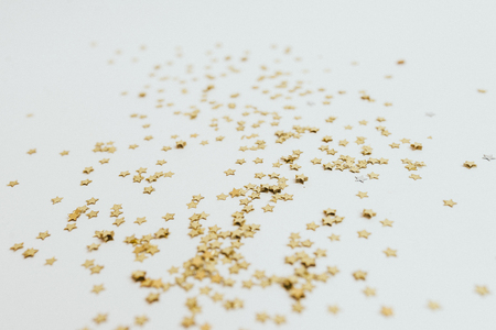 Golden stars are scattered on a white background