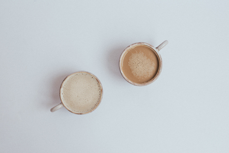 Two cups of fragrant coffee on a white table, top viewの写真素材