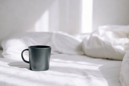 Cup of coffee on a bedの写真素材