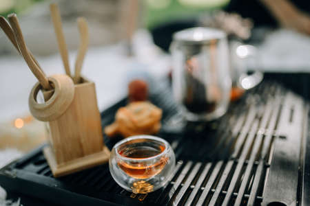 Glass cup for tea ceremony filled with red tea close upの写真素材