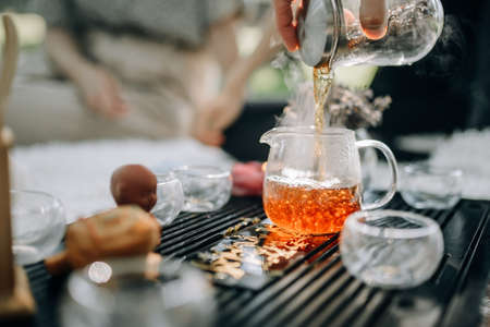 Hot freshly brewed tea steams close up. The atmosphere of the tea ceremonyの写真素材