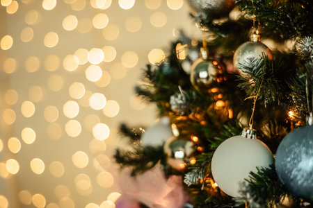 New Year background. New Year's garland and fir tree background. The fir tree is decorated with toys and lightsの写真素材