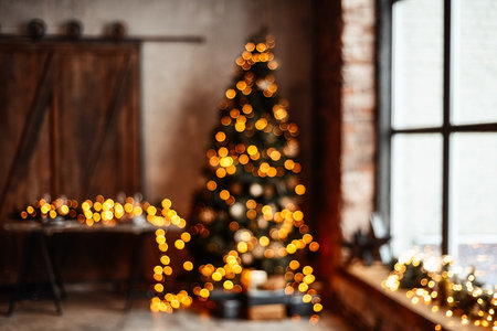 Christmas beautiful interior loft in room.New Year background. Christmas Room Interior Design, Xmas Tree Decorated By Lights Presents Gifts Toys, Candles And Garland Lighting Indoorsの写真素材