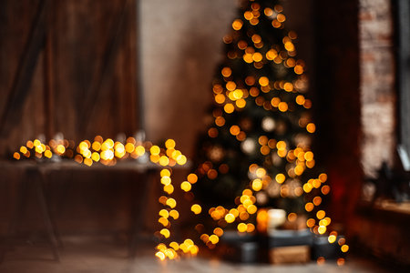 Christmas beautiful interior loft in room.New Year background. Christmas Room Interior Design, Xmas Tree Decorated By Lights Presents Gifts Toys, Candles And Garland Lighting Indoorsの写真素材
