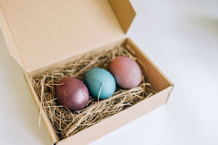 Not standard packed Easter eggs in a cardboard boxの写真素材