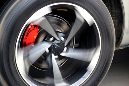 Red brake calipers on a fast-moving carの写真素材