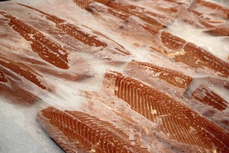 fillet salmon in ice on a store counterの写真素材