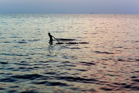 Blue crab catcher transports basket with catch in the evening, Kep, Cambodiaの写真素材
