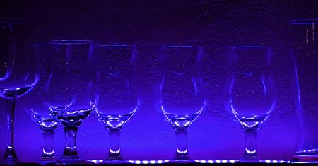 2 Wine glasses and glasses on a shelf in a barの写真素材