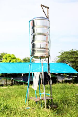 Metal vertical tank for storing water in the villageの写真素材