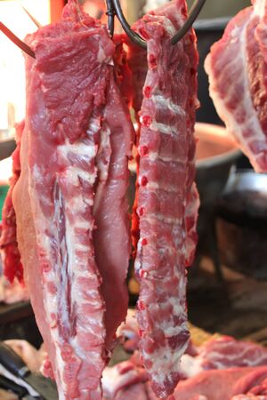 1 Fresh pork meat hanging on hooksの写真素材