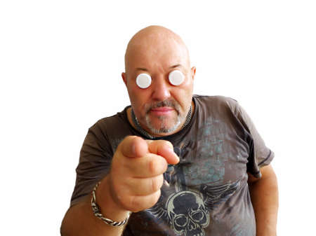 Man in a T-shirt with plugs for eyes points with a fingerの写真素材