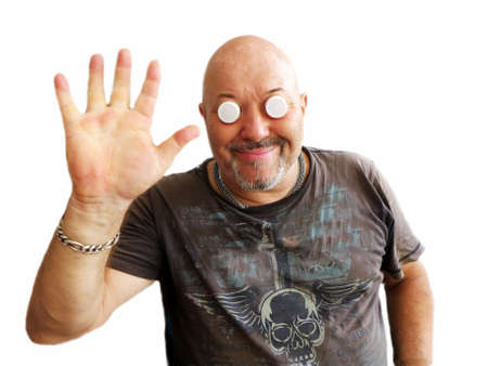 Smiling A man in a dark T-shirt with corks instead of eyes welcomesの写真素材