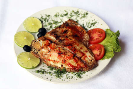 Fried fish cooked on fire, dishes of Russian national cuisine, restaurant, servingの写真素材
