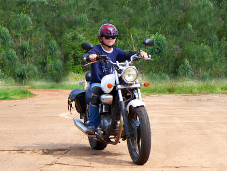 Boy learning to ride an chopper motorcycle