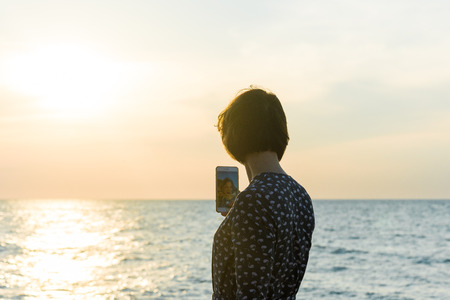 beautiful girl posing in a dress near the seaの写真素材
